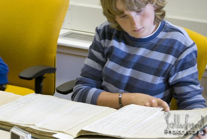 Team member examines 19th century record book